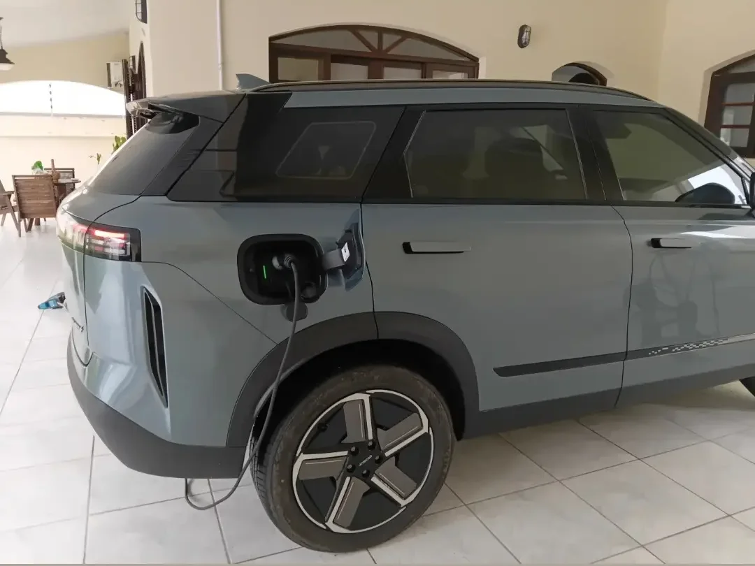 Veículo elétrico carregando em garagem residencial